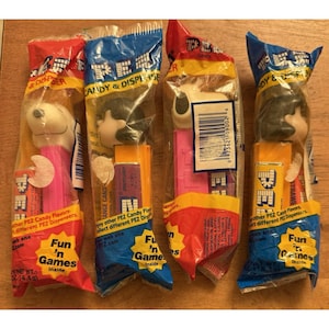 Vintage Peanuts Pez Lot of 4. 2 Snoopy (PINK), and 2 Lucy SEALED NIB