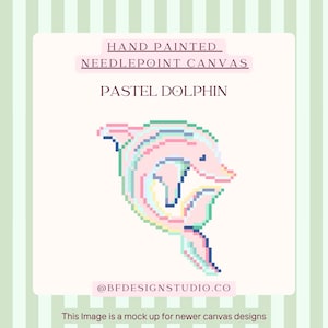 May include: Hand-painted needlepoint canvas featuring a pastel dolphin design. The dolphin is rendered in soft pink, blue, and green hues, with a pixelated aesthetic. The text "PASTEL DOLPHIN" is above the image. The image is a mock up for newer canvas designs.
