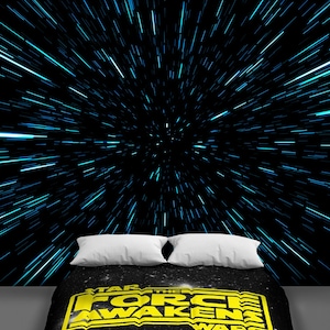 May include: A black and yellow Star Wars: The Force Awakens bedding set with a black background and a white star pattern. The bedding set features the Star Wars: The Force Awakens logo in yellow.