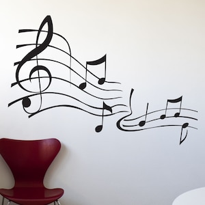 May include: Black and white music notes and treble clef wall decal. The decal features a flowing design of musical notes and a treble clef.