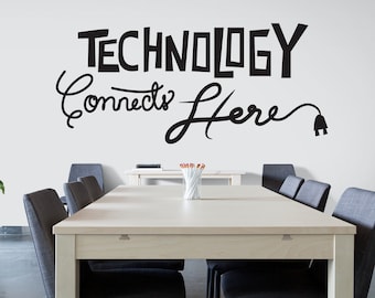 May include: A light wood conference table with black chairs in a meeting room. The wall behind the table has a black and white sign that reads "Technology Connects Here" with a stylized electrical cord and plug.