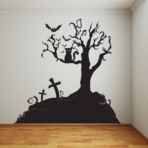 May include: Black and white Halloween wall decal featuring a spooky tree with a cat sitting on a branch, bats flying around the tree, and three crosses on a hill.