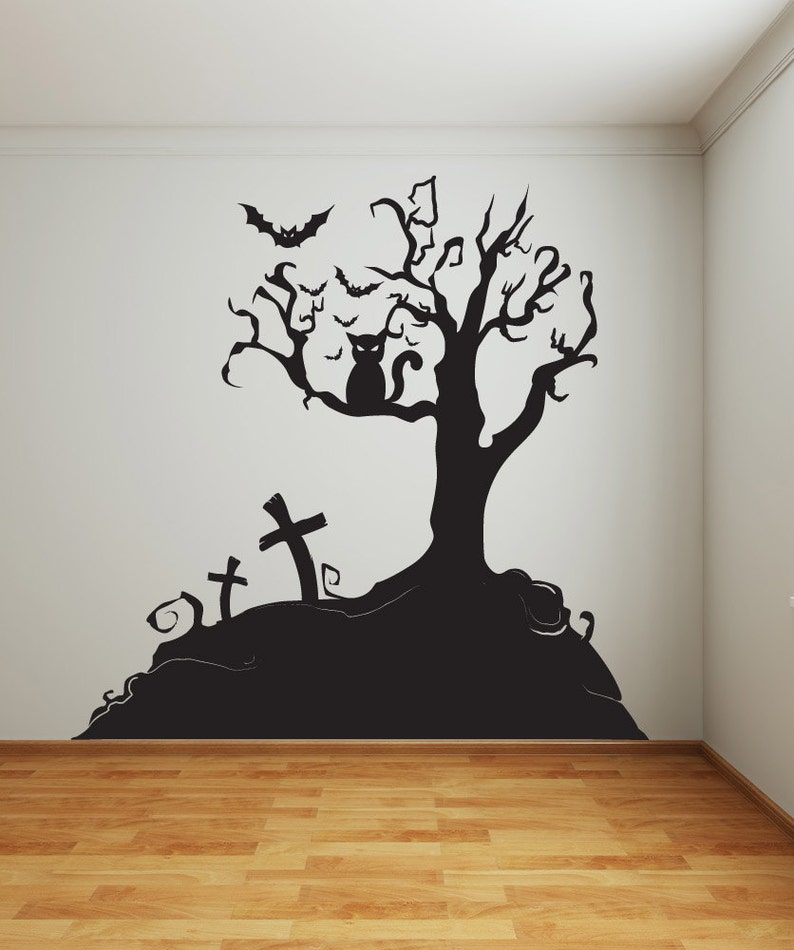 May include: Black and white Halloween wall decal featuring a spooky tree with a cat sitting on a branch, bats flying around the tree, and three crosses on a hill.