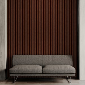 May include: A gray fabric sofa with a low profile and metal legs sits in front of a wall with vertical wood panels.
