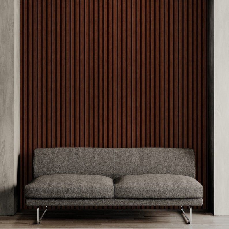 May include: A gray fabric sofa with a low profile and metal legs sits in front of a wall with vertical wood panels.