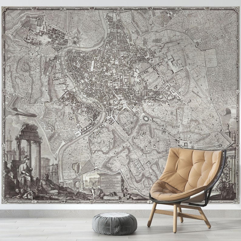 May include: A black and white vintage map of Rome, Italy, with a brown leather armchair in the foreground. The map shows the city's streets, buildings, and landmarks. The armchair is a modern design with a curved back and a comfortable seat.