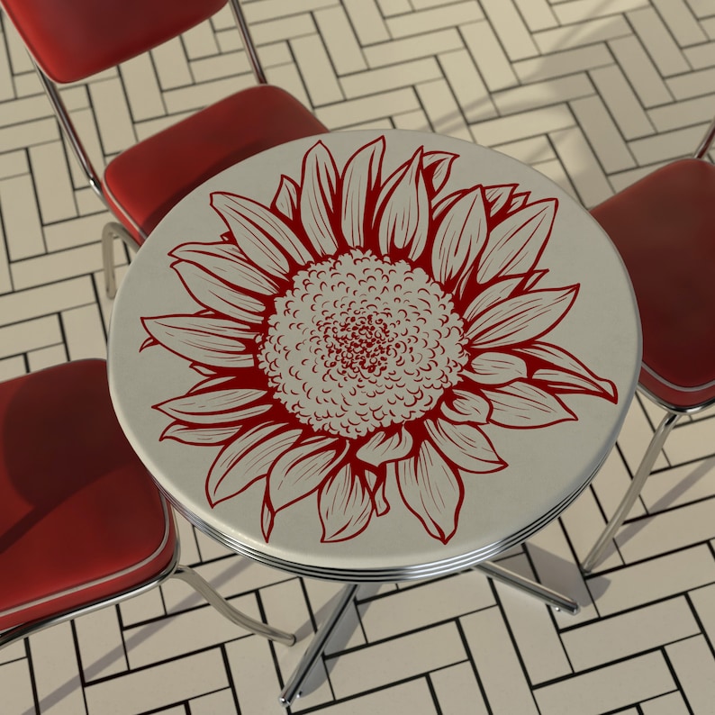 Puede incluir: Una mesa redonda blanca con un dise&ntilde;o de girasol rojo. La mesa tiene una base cromada y est&aacute; rodeada de sillas rojas.