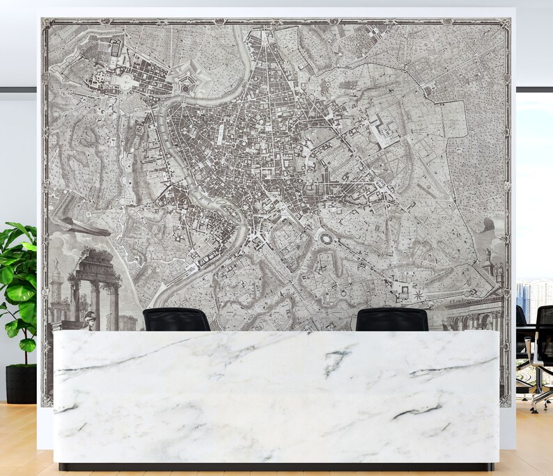 May include: A black and white vintage map of Rome, Italy, printed on a wall behind a white marble reception desk.