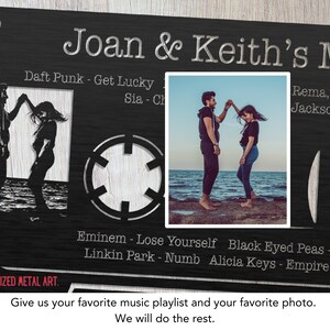 May include: A black metal cassette tape design with a couple dancing on the beach in a photo cutout. The text "Joan & Keith's Mix" is at the top of the design. The cassette tape has a list of songs on it, including "Daft Punk - Get Lucky", "Sia - Ch", "Rema, Selena G", "Jackson - Beat D", "Eminem - Lose Yourself", "Black Eyed Peas - I Gotta F", "Linkin Park - Numb", and "Alicia Keys - Empire State of I".