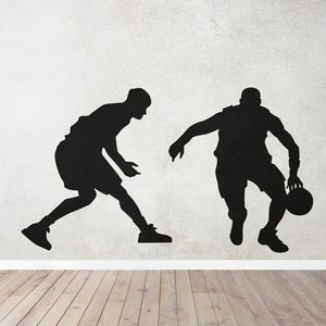 May include: Silhouettes of two basketball players, one dribbling a ball, against a white textured wall.