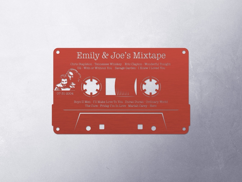 May include: A red cassette tape with a white outline and the text "Emily & Joe's Mixtape" printed on it. The cassette tape has a list of songs and artists printed on it, including Chris Stapleton, Eric Clapton, Savage Garden, Boyz II Men, Duran Duran, The Cure, and Mariah Carey.