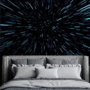 May include: A bed with a gray upholstered headboard and gray bedding positioned against a wall mural featuring a black background with bright blue light streaks radiating from the center, creating a high-speed space travel effect.