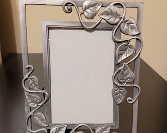Art Nouveau style pewter picture frame features an intricate ivy vine and leaf design