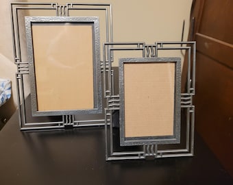 Silver metal picture frames featuring geometric Art Deco design with a hammered finish.