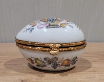 Limoges France egg shaped, hinged trinket box. Bird of paradise & fruit basket