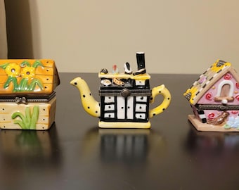 Ceramic collectible trinket boxes shaped as pink birdhouse, yellow bird house & yellow teapot