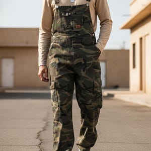 Men's slim-fit camouflage denim bib overalls with adjustable shoulder straps and multiple pockets in an urban streetwear design