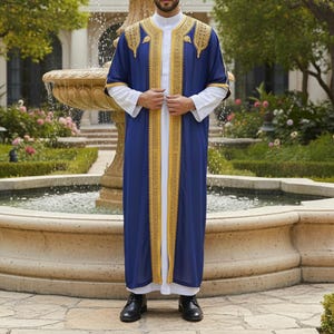 May include: A long, navy blue robe with gold embroidery and trim. The robe is worn over a white garment. The sleeves are short and the robe is open in the front. The person is wearing black shoes.