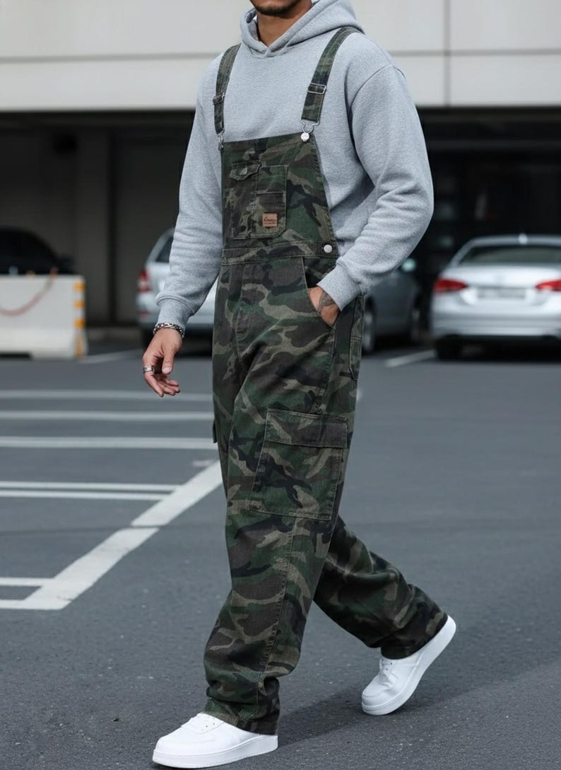 Men's slim-fit camouflage denim bib overalls with adjustable shoulder straps and multiple pockets in an urban streetwear design