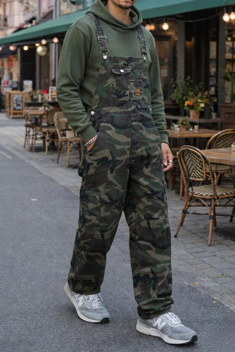 Men's slim-fit camouflage denim bib overalls with adjustable shoulder straps and multiple pockets in an urban streetwear design