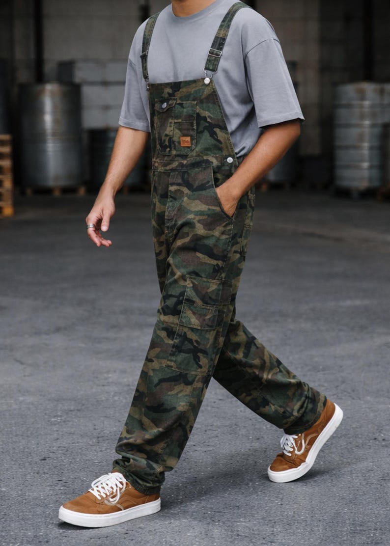 Men's slim-fit camouflage denim bib overalls with adjustable shoulder straps and multiple pockets in an urban streetwear design
