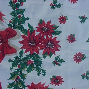 May include: White tablecloth with a red and green Christmas pattern. The pattern features poinsettia flowers, holly leaves, and red bows.