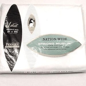 May include: A packaged white double bed sheet from Penney's. The packaging includes a black label with the text "1 sheet DOUBLE BED 81 x 99" and a green label that reads "NATION-WIDE STRONG MUSLIN 100% COTTON".