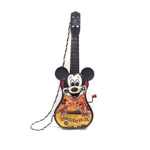 May include: Vintage Mickey Mouse guitar with a black neck, Mickey Mouse face, and a colorful body featuring Mickey and friends. The guitar has a string and a red winder. The text "MOUSE-GETAR-JR." is visible on the body.