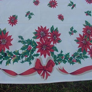 May include: White tablecloth with a red and green Christmas pattern. The pattern features poinsettia flowers, holly leaves, and red bows.