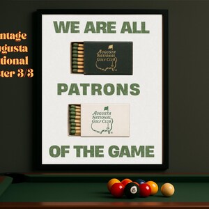 May include: A framed poster with a green and white color scheme. The poster features a vintage-style design with the text "We are all patrons of the game." and two images of matchboxes with the Augusta National Golf Club logo.