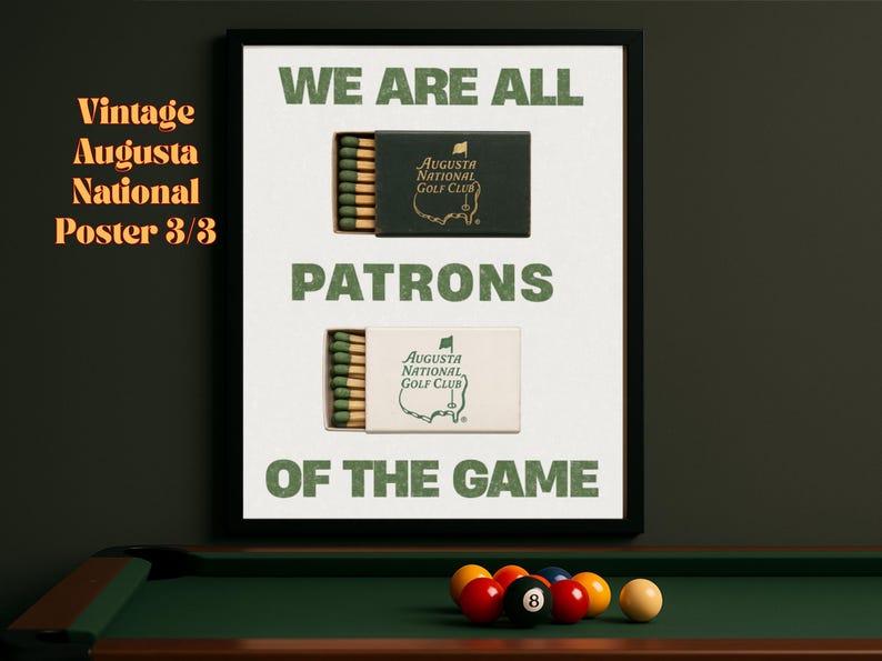 May include: A framed poster with a green and white color scheme. The poster features a vintage-style design with the text "We are all patrons of the game." and two images of matchboxes with the Augusta National Golf Club logo.