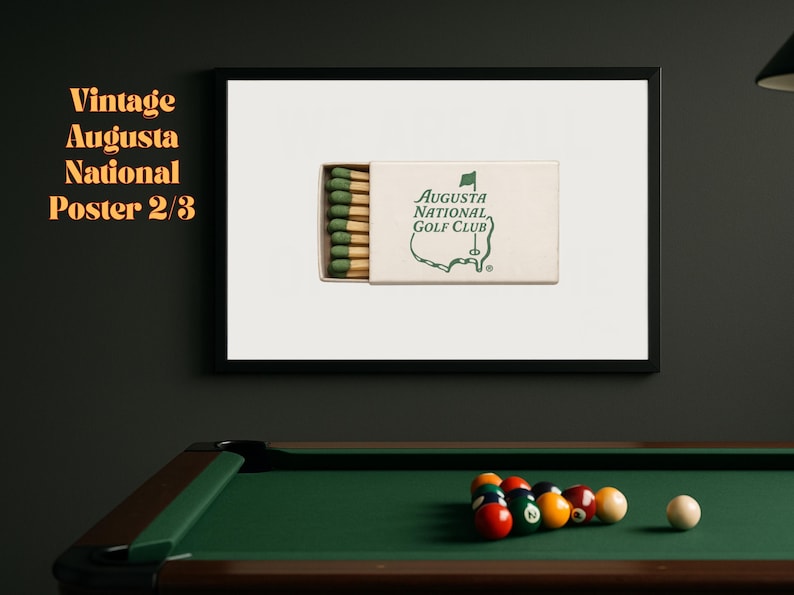 May include: A vintage poster featuring a box of matches with the Augusta National Golf Club logo. The poster is framed and hanging on a wall above a pool table.
