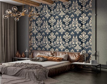 May include: A bedroom with a dark blue damask wallpaper and a bed with a brown headboard and pillows. A gold chandelier hangs from the ceiling. The bed has a gray blanket and is flanked by small tables with lamps.