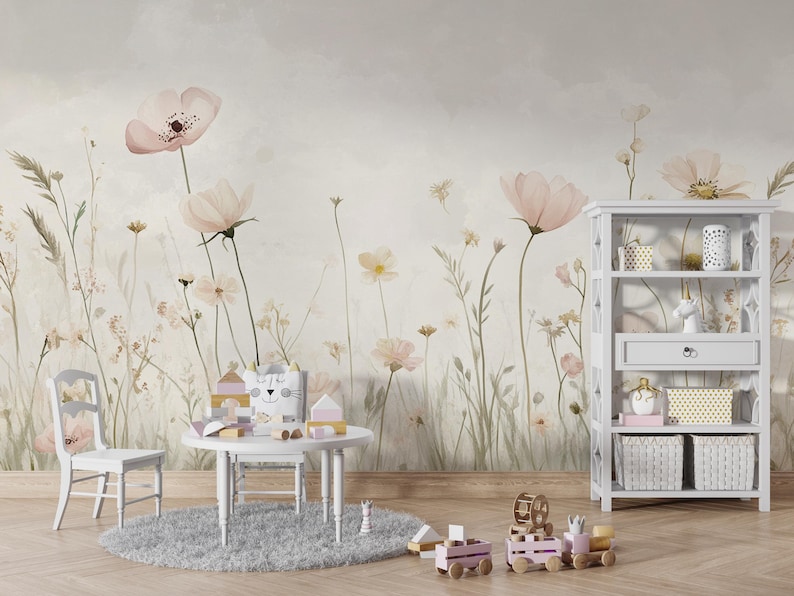 Pu&ograve; includere: Una cameretta con carta da parati floreale con grandi fiori rosa e steli verdi. Un tavolo, una sedia e una libreria bianchi sono di fronte alla carta da parati. Giocattoli e oggetti decorativi sono sul tavolo e sugli scaffali.
