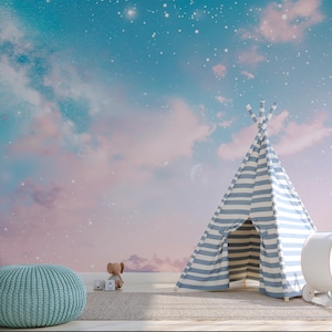 May include: A whimsical nursery scene featuring a blue and white striped teepee, a teal ottoman, and a white toy. The backdrop is a dreamy sky with clouds, stars, and a soft color palette of blue, pink, and white. A rug and a toy elephant complete the scene.