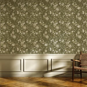 May include: An interior scene featuring olive green floral wallpaper, a wooden chair with woven seat, and a window with shutters. The room has a light-colored wainscoting and a hardwood floor with a herringbone pattern.