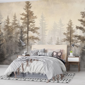 May include: A bedroom with a forest-themed mural. The bed has a light wood headboard, a white comforter, and decorative pillows. A patterned rug and a potted plant add to the room's decor. Two bedside tables with lamps complete the scene.
