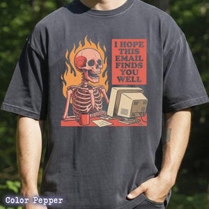 May include: A white ceramic mug with a black handle and the text "But First, Coffee" in a bold, black font. The mug is set against a blurred background, suggesting a cozy setting.