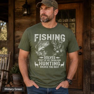May include: Military green t-shirt with the text "FISHING SOLVES MOST OF MY PROBLEMS HUNTING SOLVES THE REST." The graphic includes a fish and a deer. The shirt is a crew neck and short-sleeved.