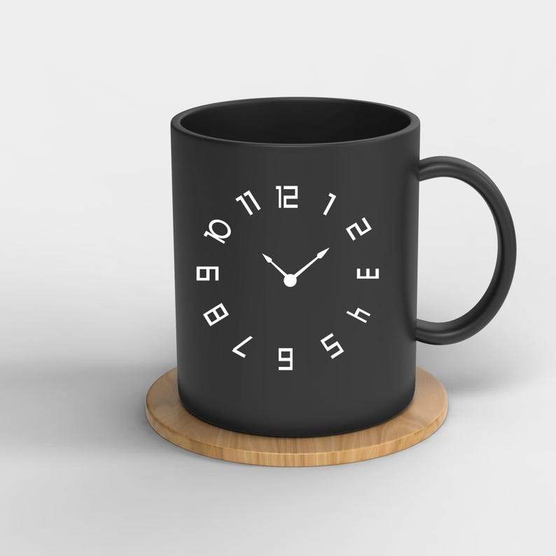 May include: A black ceramic mug with a clock face design. The mug has a white clock face with black hands and black numbers. The mug is sitting on a wooden coaster.