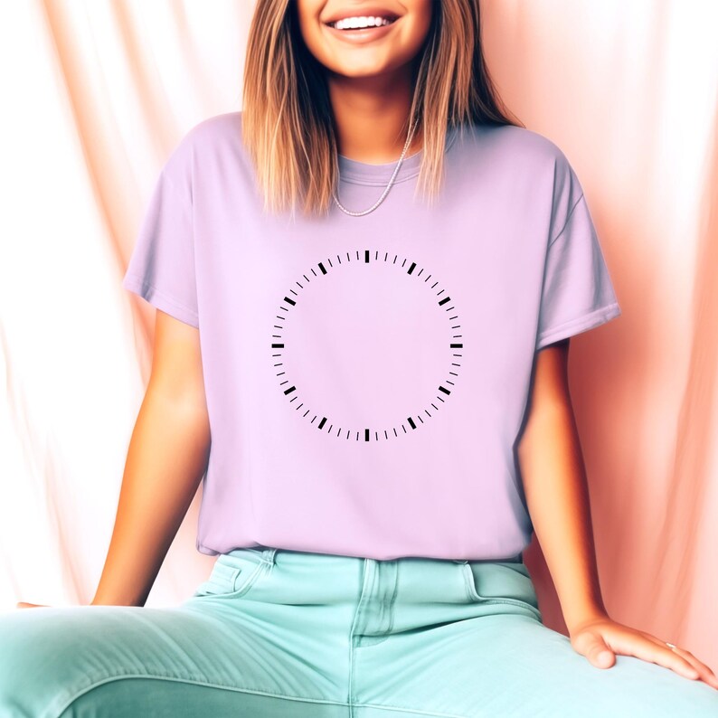 May include: A lavender t-shirt with a black clock face design on the front. The clock face has no hands.