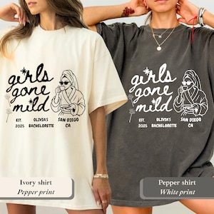 Op de afbeelding: Twee T-shirts, &eacute;&eacute;n ivoor en &eacute;&eacute;n peper, met de tekst "girls gone mild" en een afbeelding van een vrouw in een badjas en zonnebril. De tekst bevat "EST. 2025 OLIVIA'S BACHELORETTE SAN DIEGO CA".