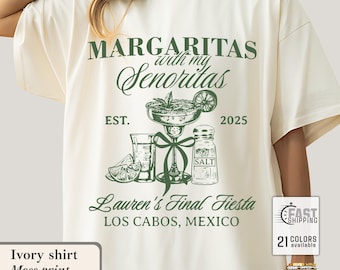 May include: An ivory t-shirt featuring a moss green print. The design includes the text "MARGARITAS with my Senoritas" and a margarita glass, salt shaker, and lime. The text "Lauren's Final Fiesta, Los Cabos, Mexico" is also included.