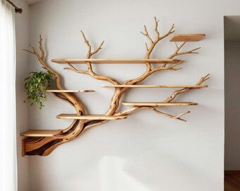 May include: A unique wooden wall shelf designed to resemble a tree. The shelf has multiple horizontal platforms of varying sizes, supported by a central trunk and branches. A small plant in a pot is placed on one of the shelves. The shelf is mounted on a white wall.
