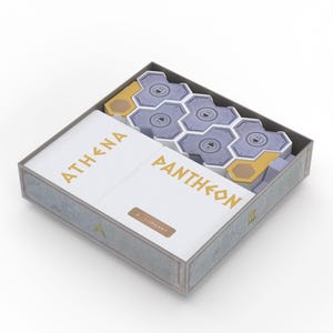 May include: A board game box titled "ATHENA PANTHEON" in gold lettering. Inside the grey box are hexagonal tiles, cards and other game pieces. The box has a white interior.
