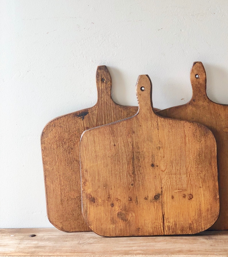 Lovely and rustic, these vintage French bread boards will add authentic character and decor to your French farmhouse, country French, or European country inspired space! Come discover more French Farmhouse Decor inspired by Fixer Upper and click here to Get the Look of The Club House Kitchen & Sun Room. #fixerupper #joannagaines #kitchendecor #frenchfarmhouse