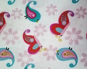May include: A white fabric featuring a repeating pattern of stylized birds and butterflies. The birds are teal with pink and gold accents, while the butterflies are red and pink with light blue details. Pale pink flowers are scattered throughout.