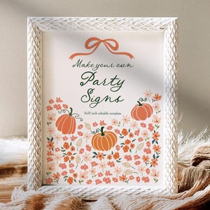 Puede incluir: Un letrero enmarcado de 20x25 cm con un marco blanco texturizado. El letrero presenta el texto "Make your own Party Signs" con calabazas naranjas e ilustraciones florales. Un lazo está en la parte superior del letrero.