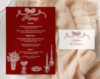 May include: A red menu card and place card with white script and illustrations. The menu card lists starters, main course, and dessert options. The place card has the name "Jordan Williams". The cards are on a white plate and beige cloth.