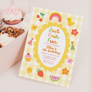 May include: A box of assorted cupcakes next to a rectangular birthday invitation card with a yellow gingham pattern. The card features a scalloped yellow oval frame, colourful icons of cherries, a rainbow, a chick, flowers, party hats, and fruit, with the text Just Four Fun, Ellie's 4th birthday, and event details.